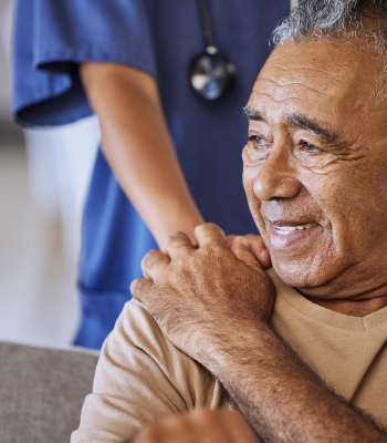 Patient holding hand of caregiver